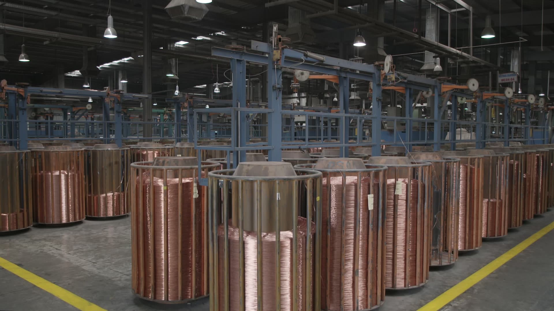 Large copper spools in a manufacturing facility production floor